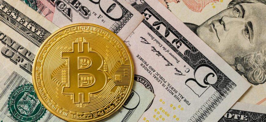 Close-up of a gold Bitcoin coin placed on various US dollar bills, illustrating digital currency concepts.