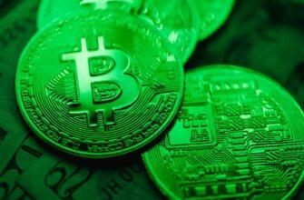 Close-up of green-illuminated Bitcoin coins representing digital currency and blockchain technology.