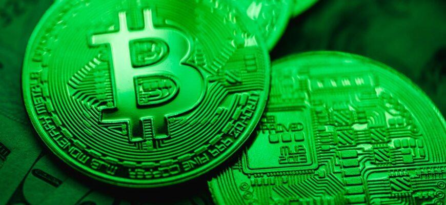 Close-up of green-illuminated Bitcoin coins representing digital currency and blockchain technology.