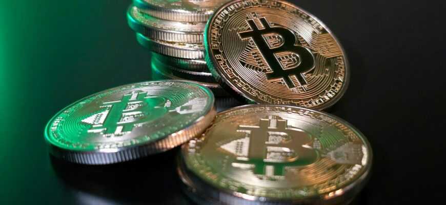 a pile of bitcoins sitting on top of a table