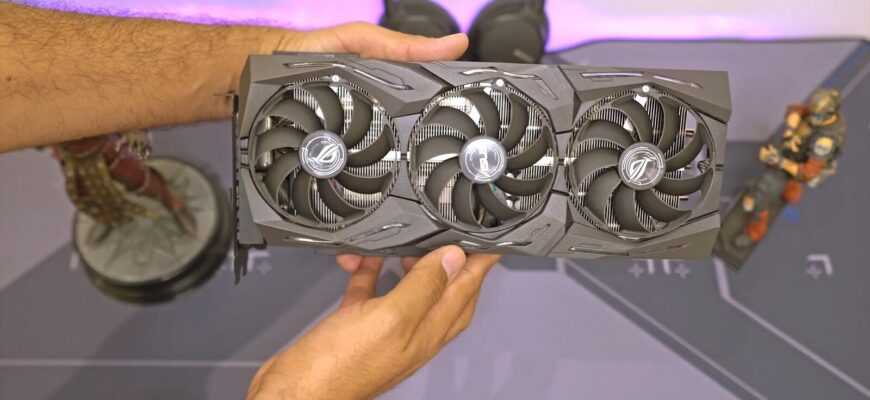 a person holding a computer fan in their hand