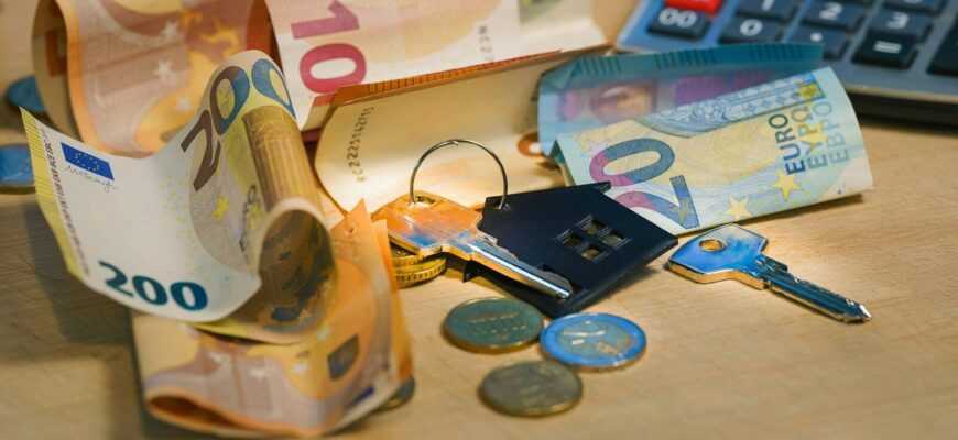 A pile of money sitting next to a calculator