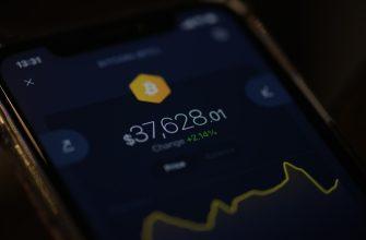 a close up of a cell phone with a bitcoin on it