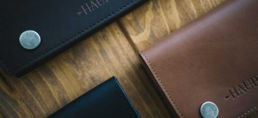 three brown and black Haupes leather wallets