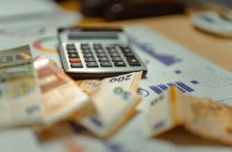 A calculator sitting on top of a pile of money